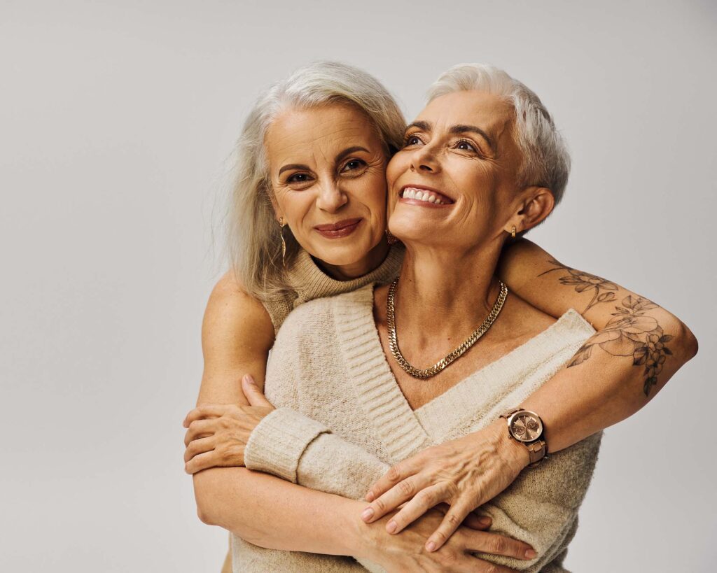 mature fashionable tattooed woman hugging