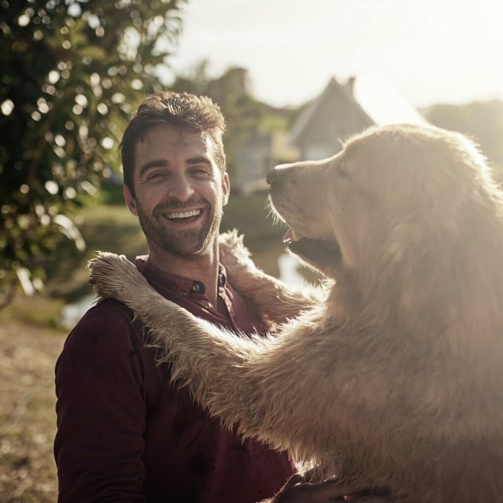 Happy man with his dog in park